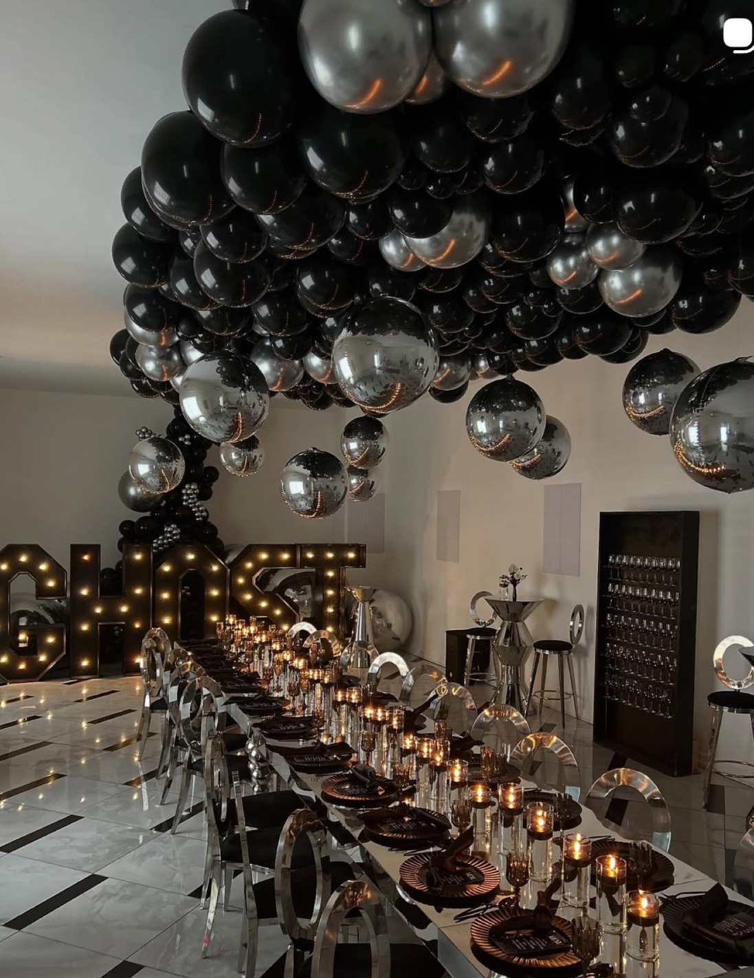 Black chrome balloon ceiling and mirrored dinner table